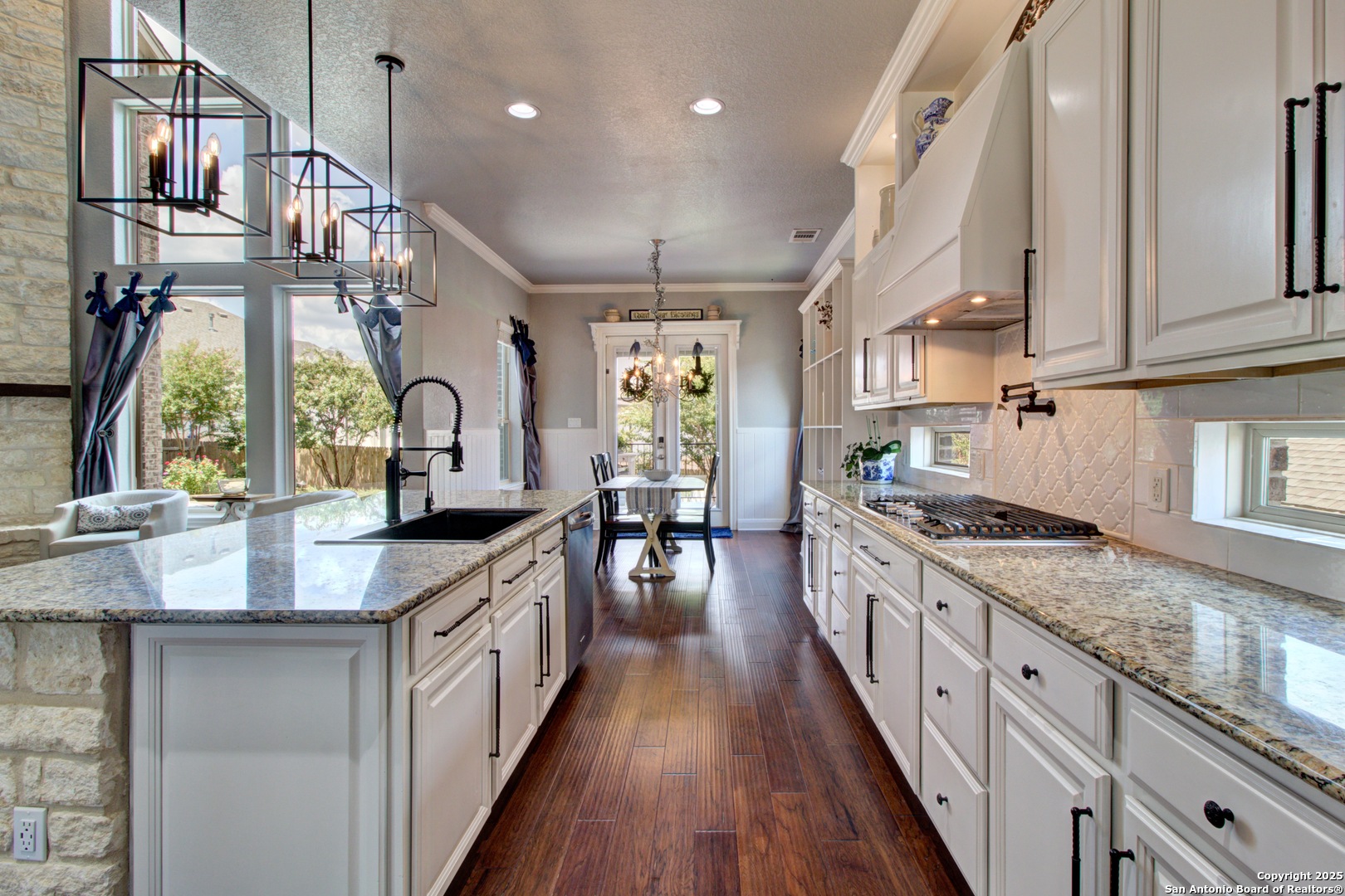 28518 Tristant Ridge San Antonio, TX 78260 - Photo 13 of 43 a kitchen with stainless steel appliances granite countertop a lot of counter space and wooden floors