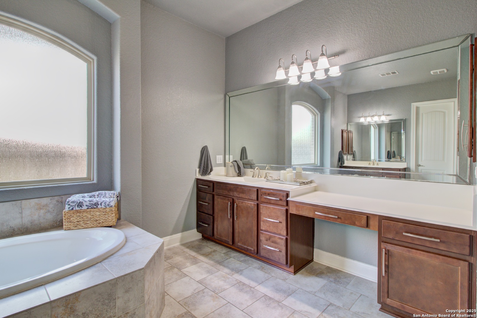 28518 Tristant Ridge San Antonio, TX 78260 - Photo 21 of 43 a spacious bathroom with a granite countertop sink a mirror and a bathtub