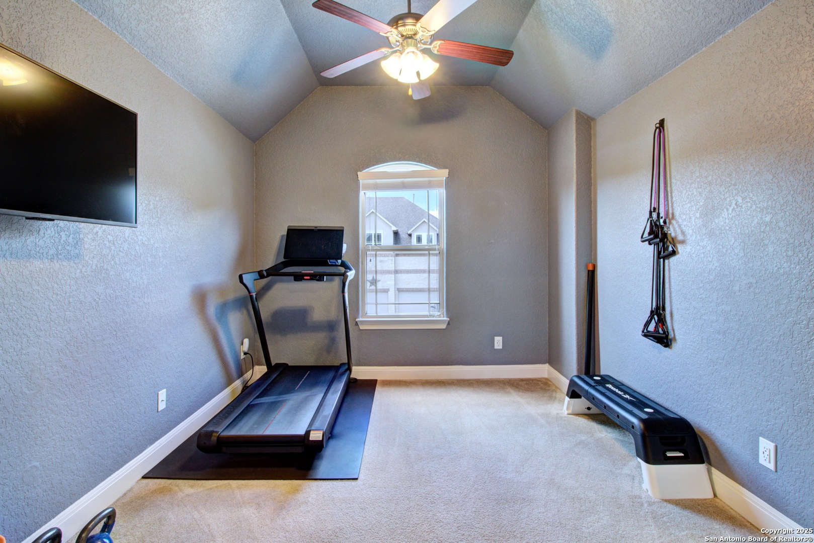 28518 Tristant Ridge San Antonio, TX 78260 - Photo 28 of 43 a room with gym equipment and a flat screen tv