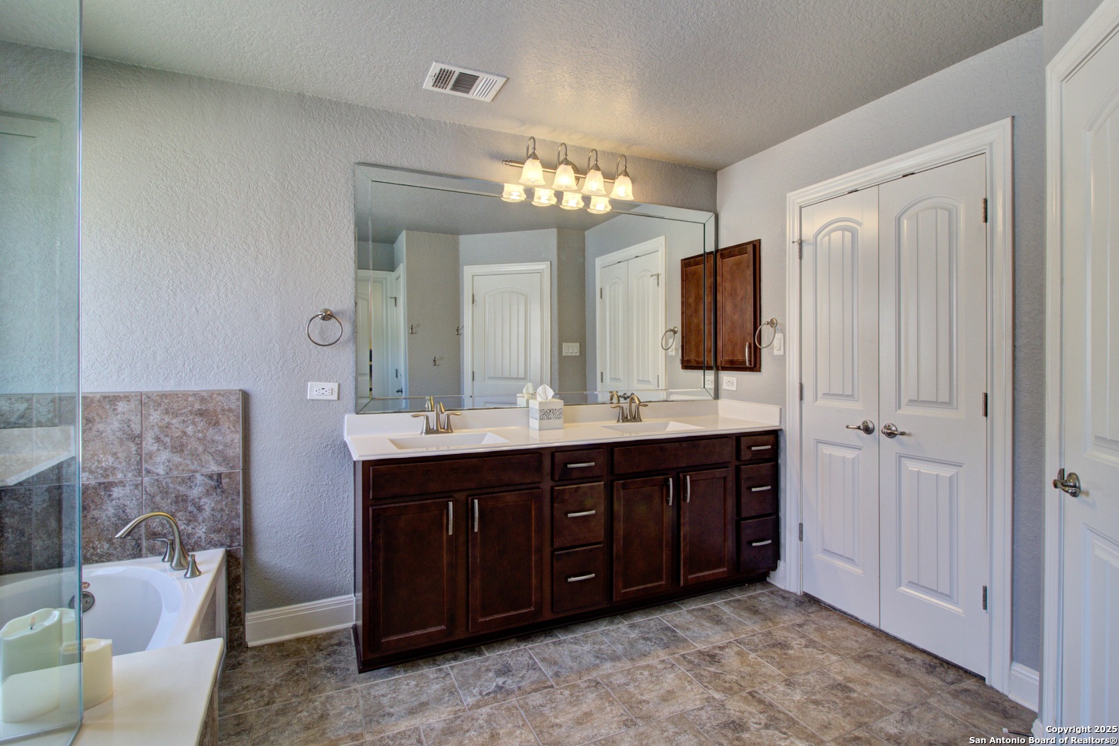 28518 Tristant Ridge San Antonio, TX 78260 - Photo 32 of 43 a bathroom with a double vanity sink double vanity and a mirror