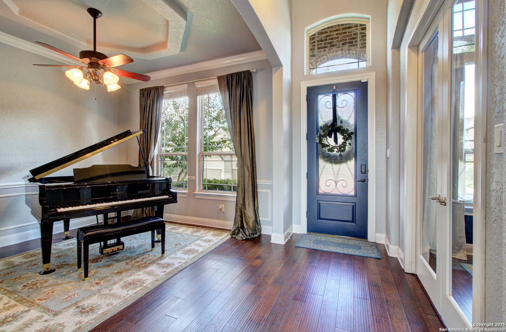 28518 Tristant Ridge San Antonio, TX 78260 - Photo 7 of 43 a living room with a piano and a wooden floor