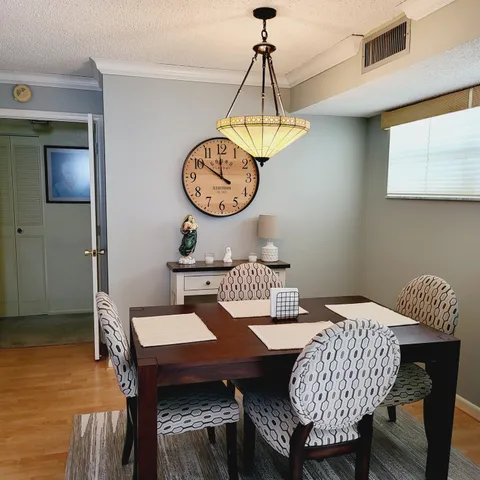 a view of a dining room with furniture wooden floor and chandelier