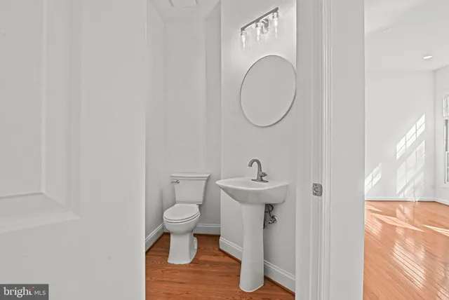 a view of empty room with wooden floor and ceiling fan