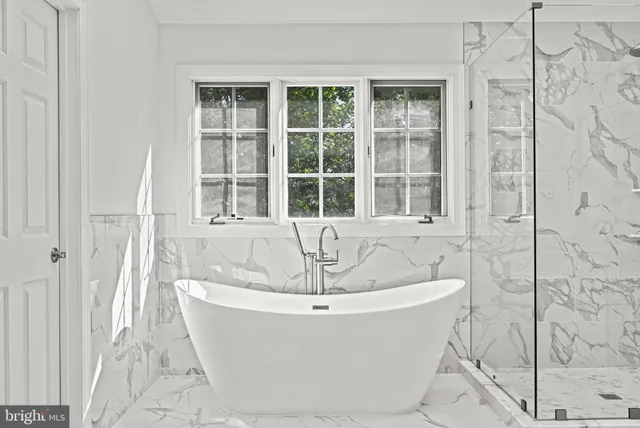 a spacious bathroom with a sink and a mirror