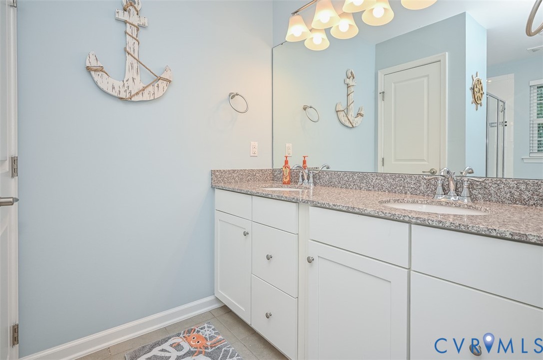 8990 Ringview Drive Mechanicsville, VA 23116 - Photo 24 of 39 Primary bath featuring double vanity, light tile f