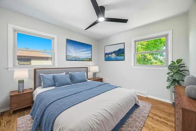a bedroom with a large bed and a potted plant