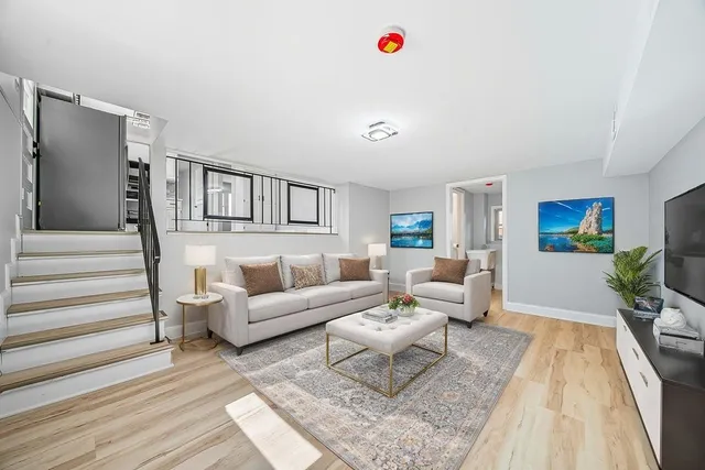 a living room with furniture and a wooden floor