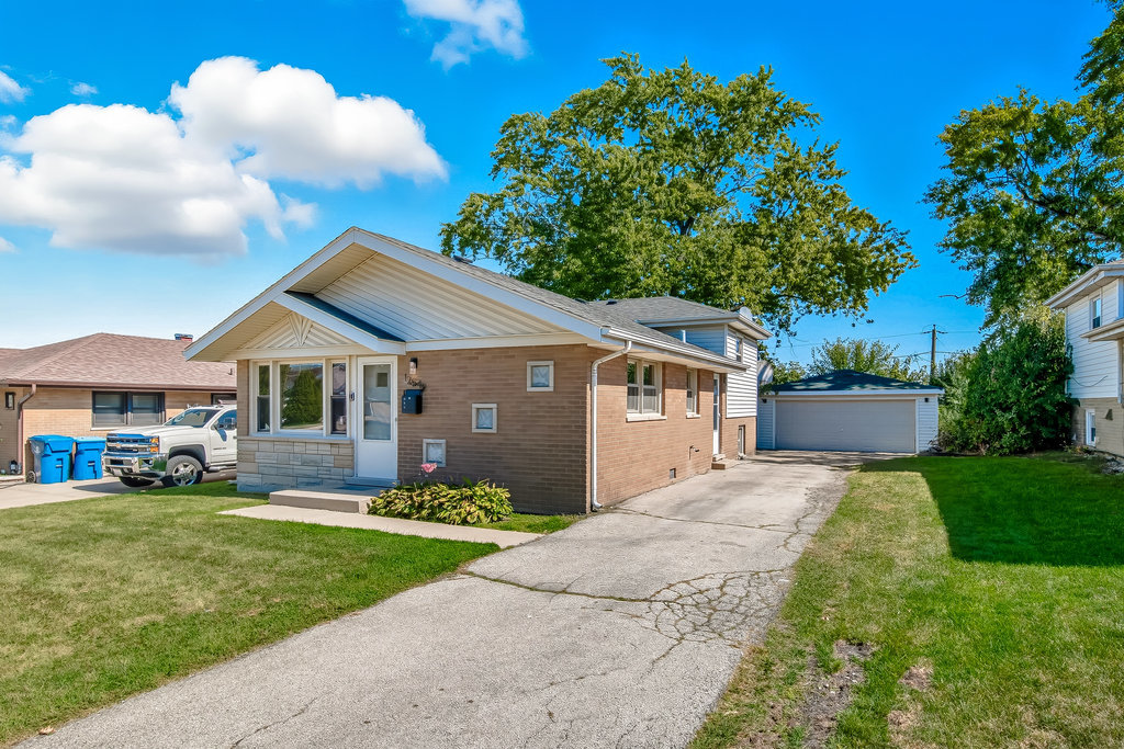 12549 South Tripp Avenue Alsip, IL 60803 - Photo 21 of 30 a front view of a house with a yard and garage