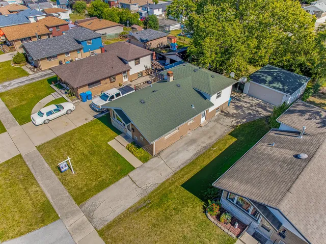 an aerial view of a house with a garden and swimming pool