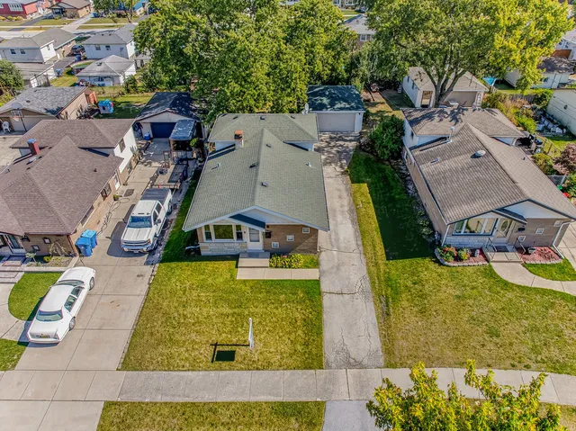 an aerial view of a house with swimming pool and outdoor space