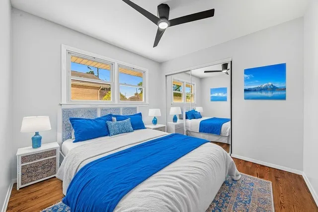 a bedroom with a bed and wooden floor