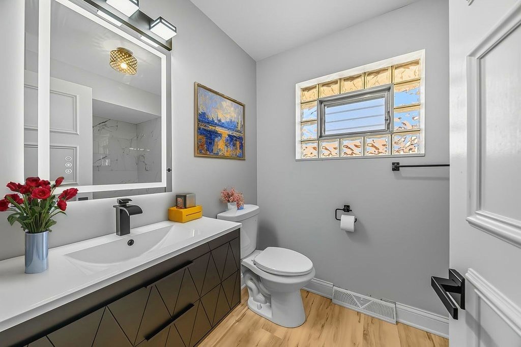 12549 South Tripp Avenue Alsip, IL 60803 - Photo 10 of 30 a bathroom with a sink mirror vanity and toilet