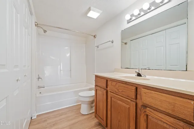 a bathroom with a tub a sink and a large mirror