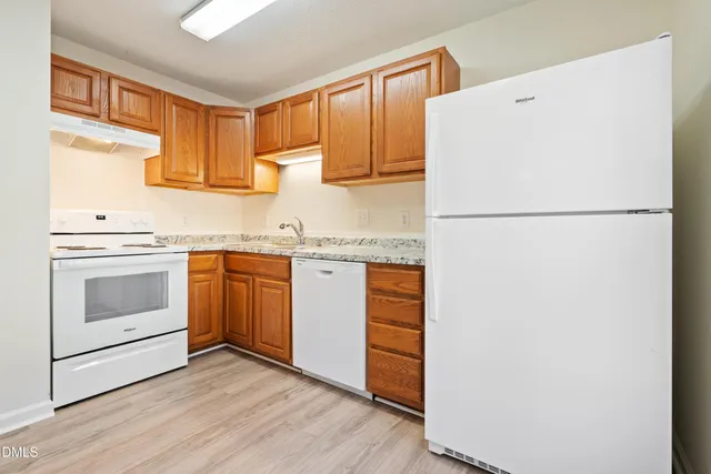 a white refrigerator freezer sitting inside of a kitchen