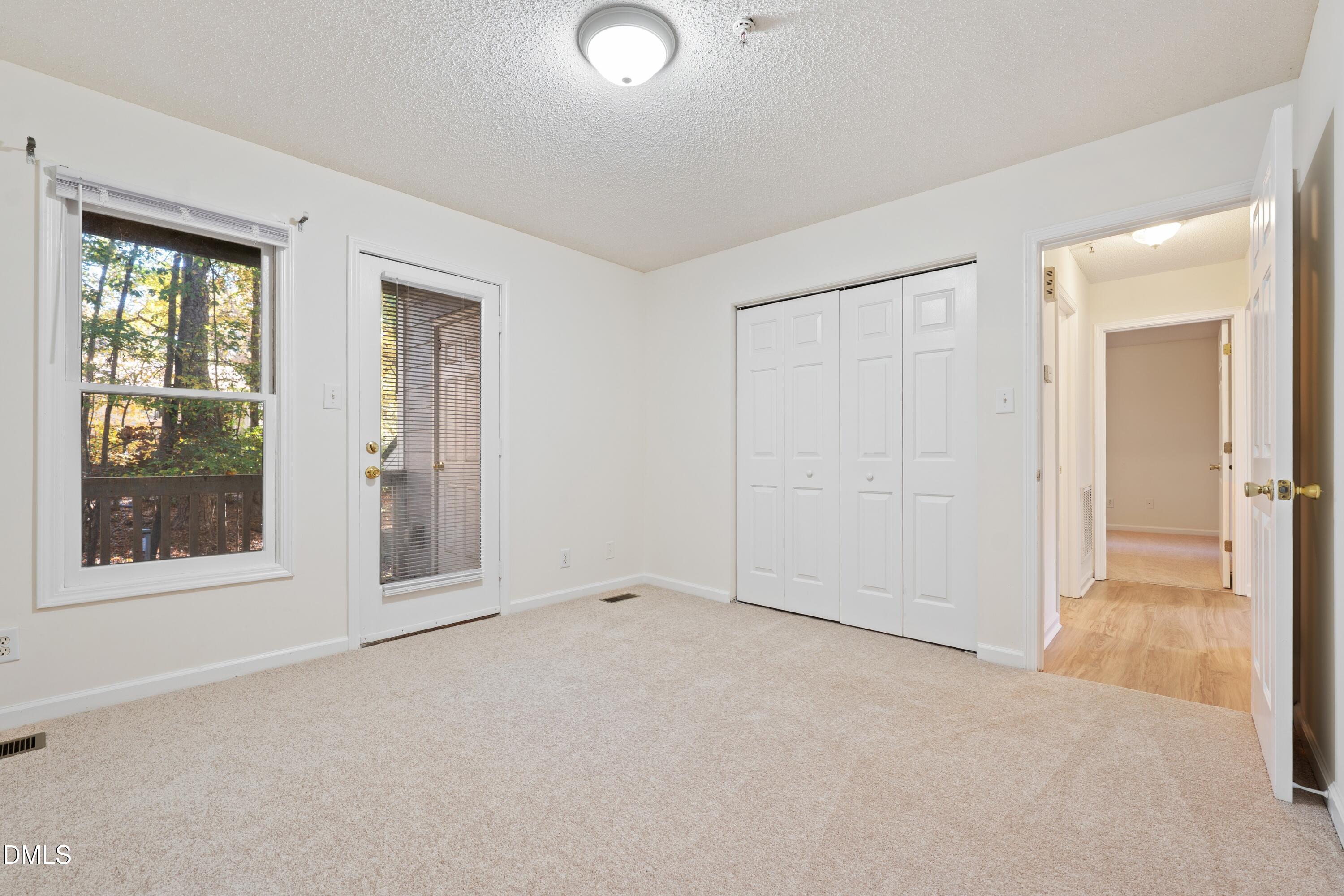 121 Westview Drive, Unit 33 Carrboro, NC 27510 - Photo 10 of 13 an empty room with windows and closet