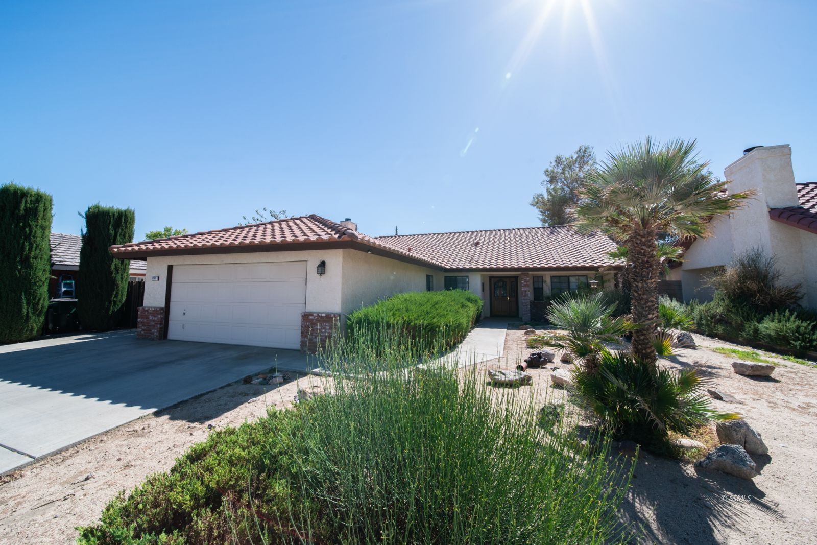 1205 Flora Way Ridgecrest, CA 93555 - Photo 1 of 46 a front view of a house with a yard and garage
