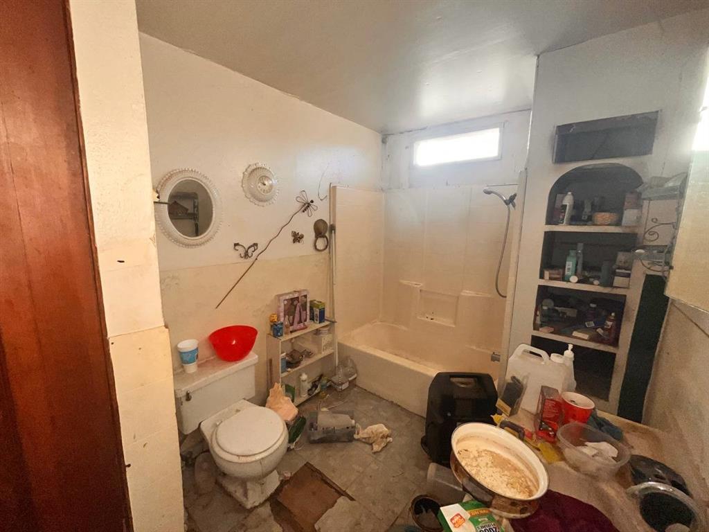 516 Commerce Street Pleasanton, TX 78064 - Photo 4 of 10 a bathroom with a sink toilet and shower