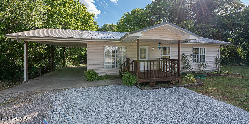 1330 White Oak Road Dayton, TN 37321 - Photo 1 of 20 a view of a house with a yard and lawn chairs under an umbrella