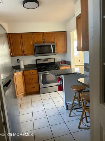 a kitchen with stainless steel appliances granite countertop a sink and cabinets