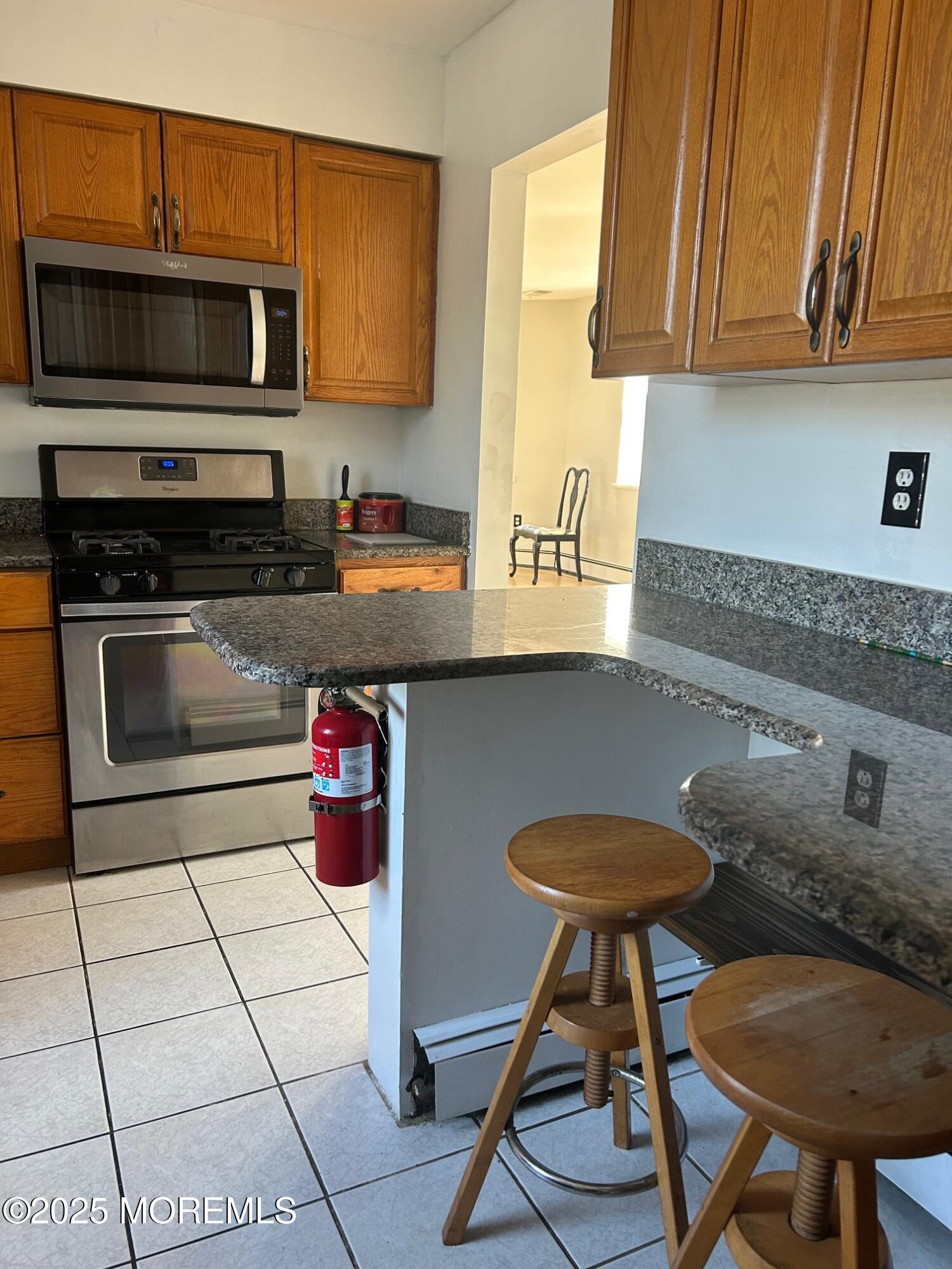 31 Main Street, Unit UPSTAIRS Englishtown, NJ 07726 - Photo 4 of 10 a kitchen with stainless steel appliances granite countertop a sink and cabinets
