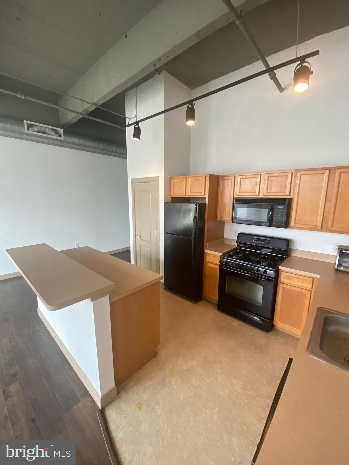 511 North Broad Street, Unit 202 Philadelphia, PA 19123 - Photo 19 of 29 a kitchen with stainless steel appliances a refrigerator and a stove