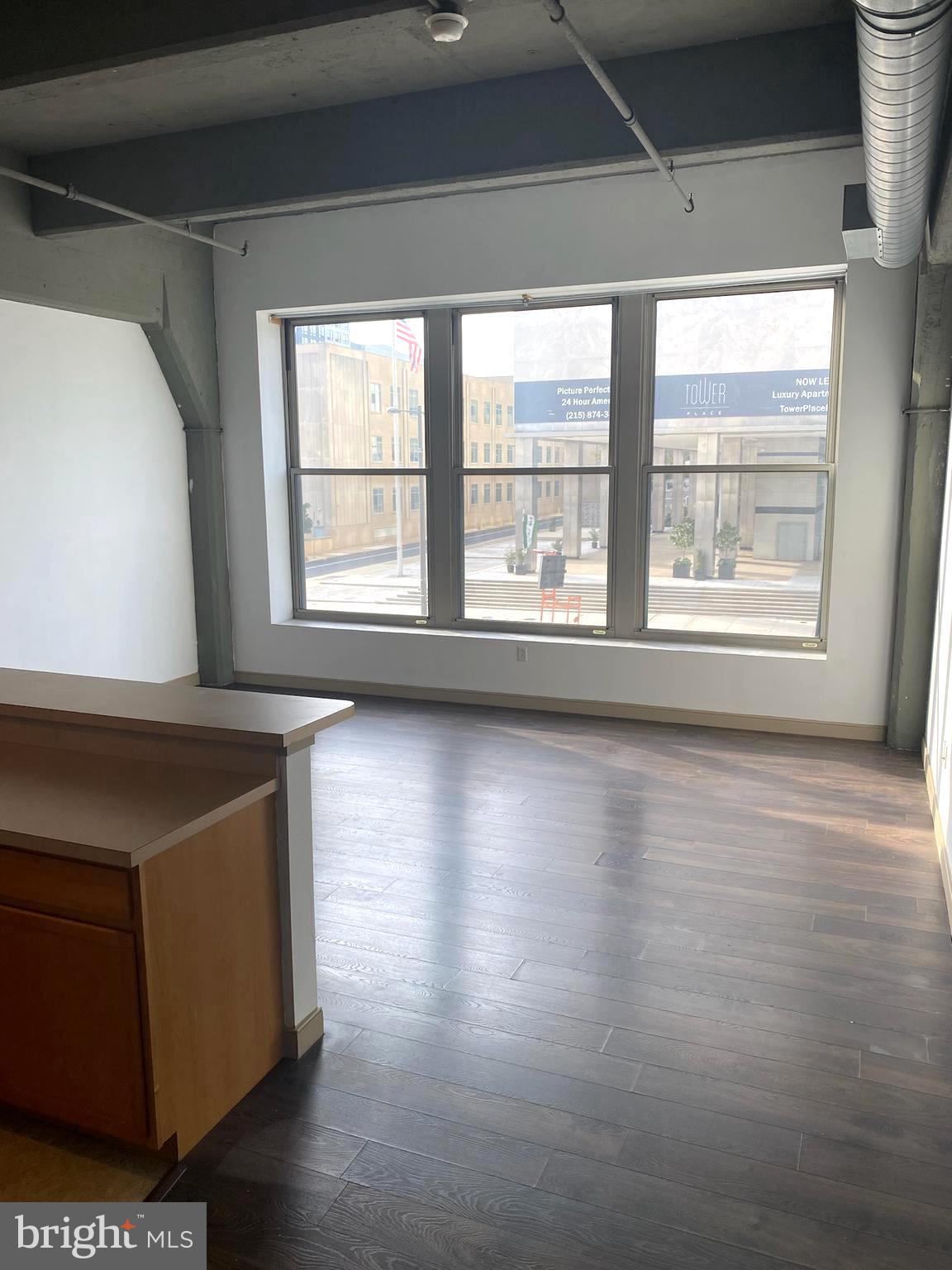 511 North Broad Street, Unit 202 Philadelphia, PA 19123 - Photo 22 of 29 a view of an empty room with wooden floor and a window