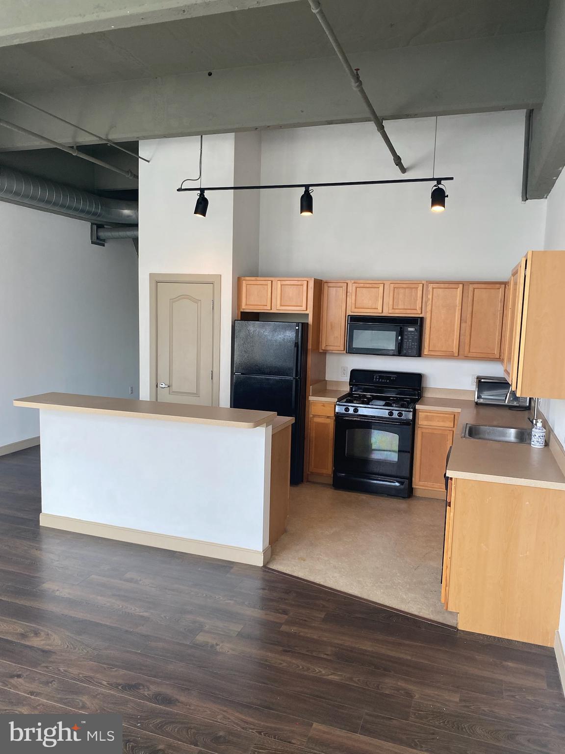 511 North Broad Street, Unit 202 Philadelphia, PA 19123 - Photo 7 of 29 a kitchen with stainless steel appliances a refrigerator a stove and a sink