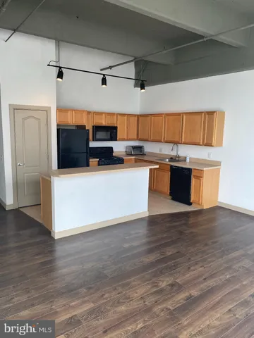 a view of kitchen with microwave and cabinets