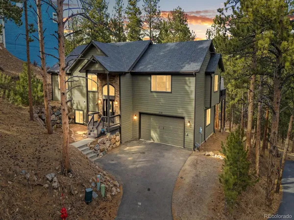a view of house with yard and outdoor seating