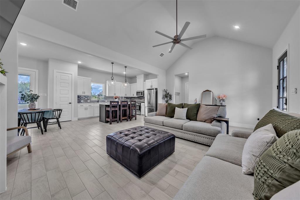 2004 Willy Dilly Road Springtown, TX 76082 - Photo 11 of 40 Open-concept living space featuring wood-finish flooring, vaulted ceilings, recessed lighting, and a modern ceiling fan