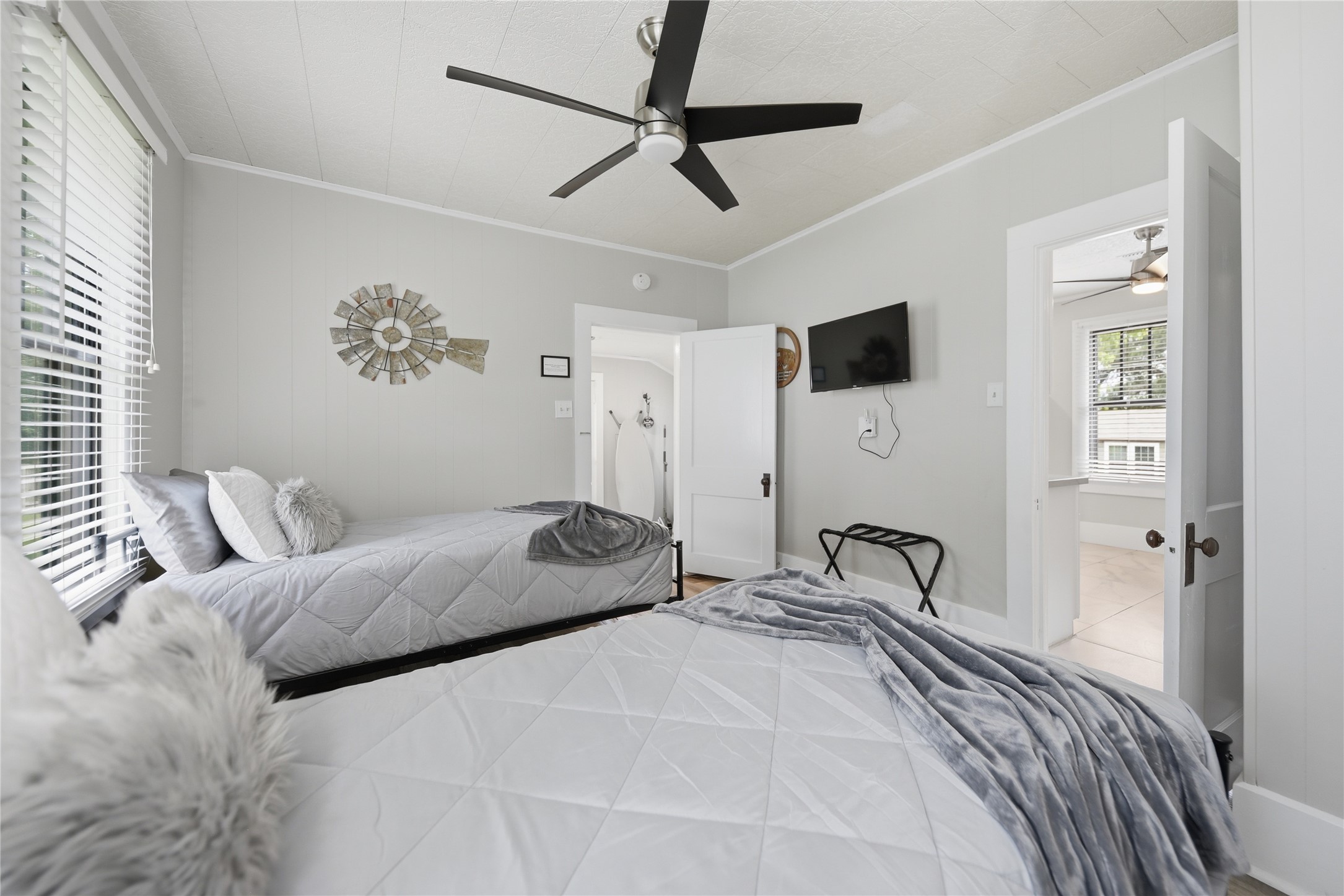 1500 Church Street Brenham, TX 77833 - Photo 18 of 30 a bedroom with a bed and a chandelier