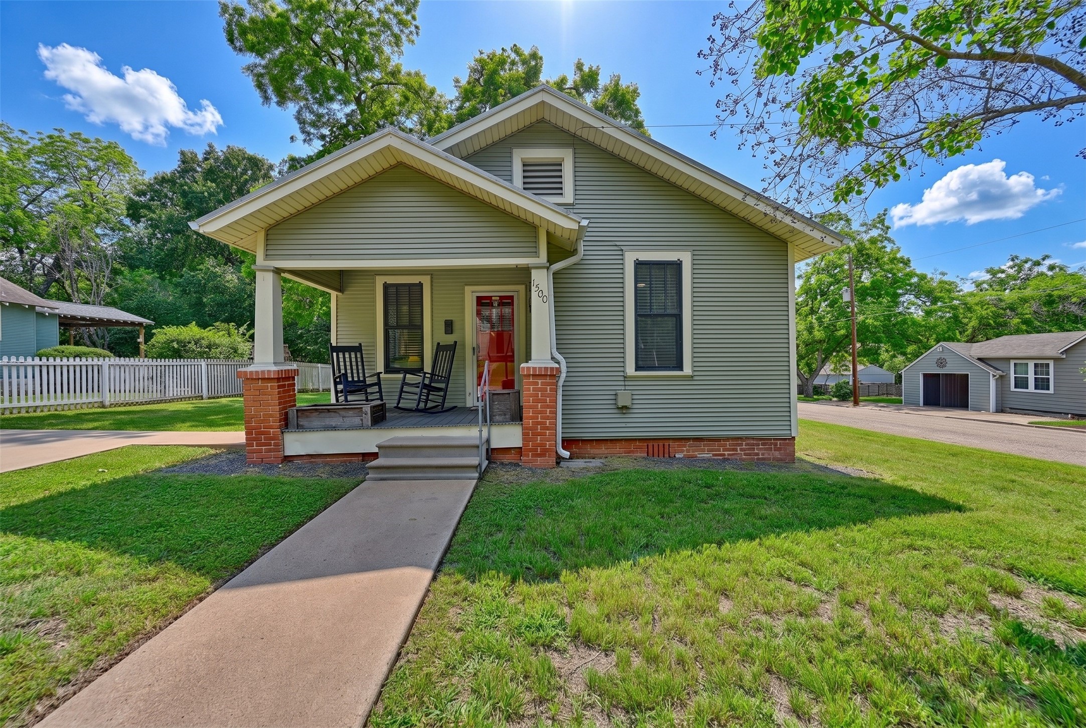 1500 Church Street Brenham, TX 77833 - Photo 28 of 30 a front view of a house with a yard and porch