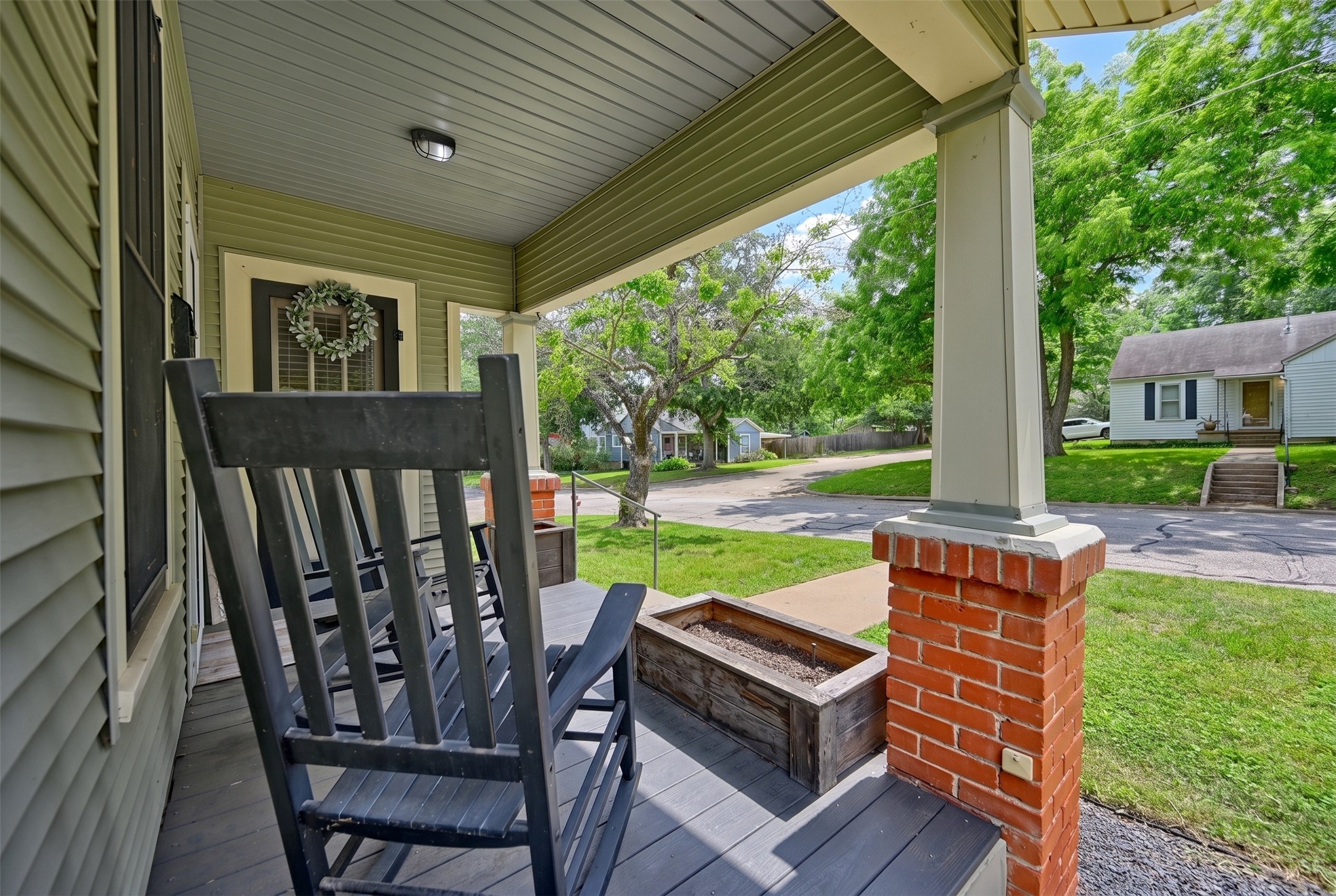 1500 Church Street Brenham, TX 77833 - Photo 3 of 30 a view of a patio with table and chairs potted plants with wooden floor and fence