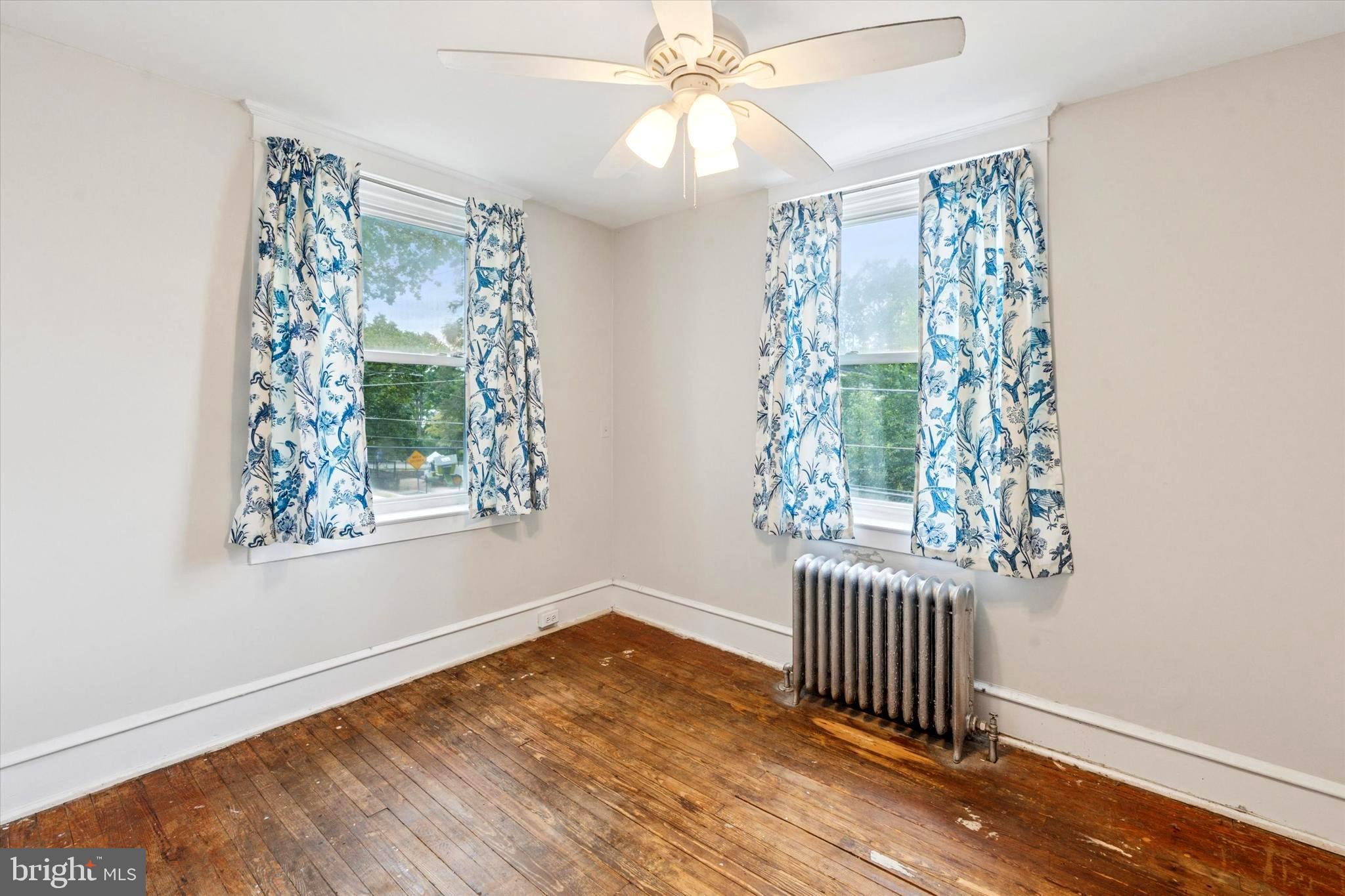 124 Arnold Road Ardmore, PA 19003 - Photo 17 of 24 an empty room with wooden floor fan and windows