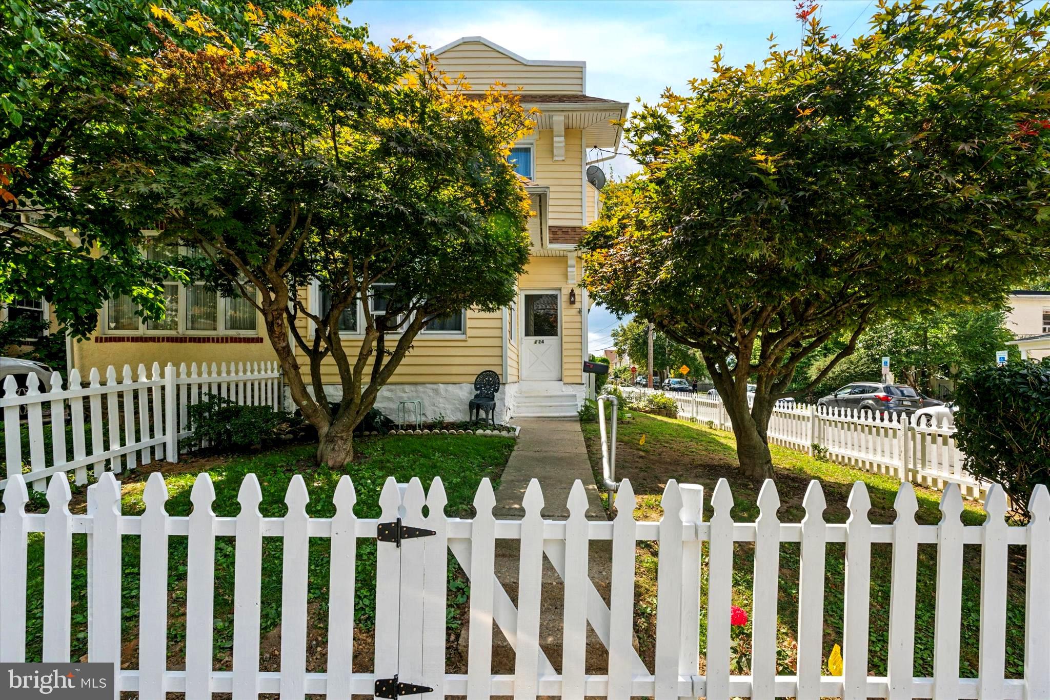 124 Arnold Road Ardmore, PA 19003 - Photo 2 of 24 a front view of white house with a garden