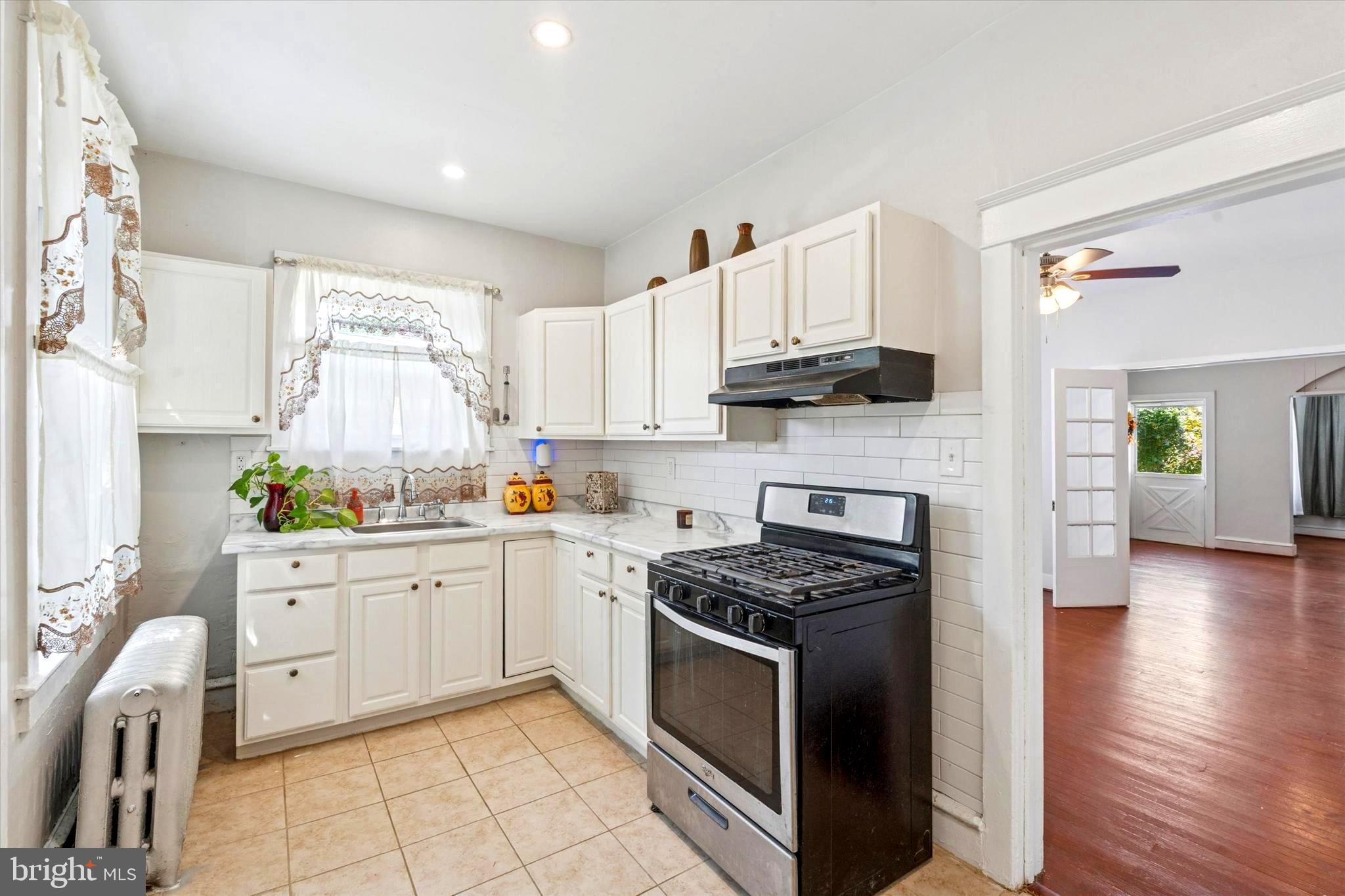 124 Arnold Road Ardmore, PA 19003 - Photo 24 of 24 a kitchen with cabinets stainless steel appliances and wooden floor