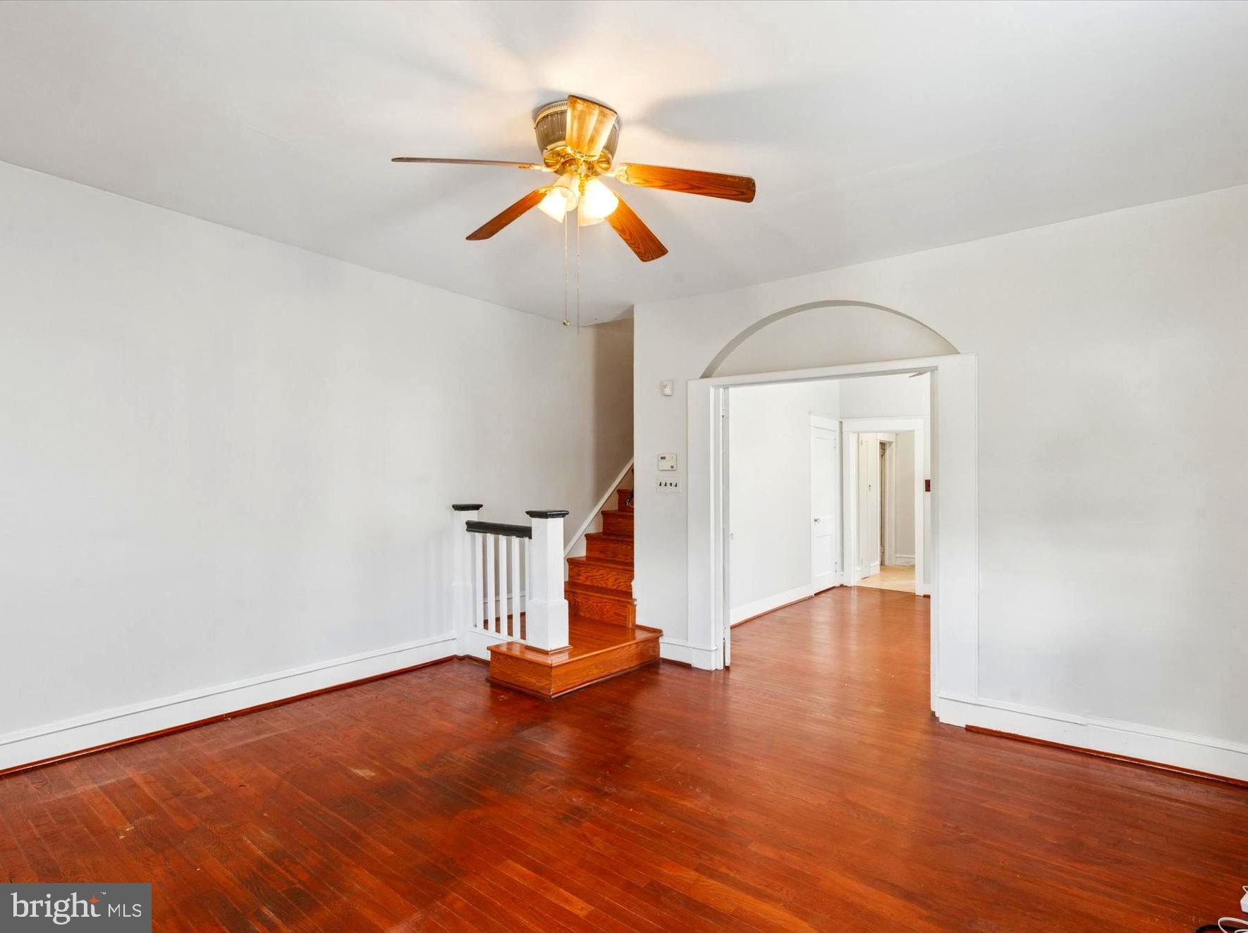 124 Arnold Road Ardmore, PA 19003 - Photo 5 of 24 a view of an empty room with wooden floor and a window