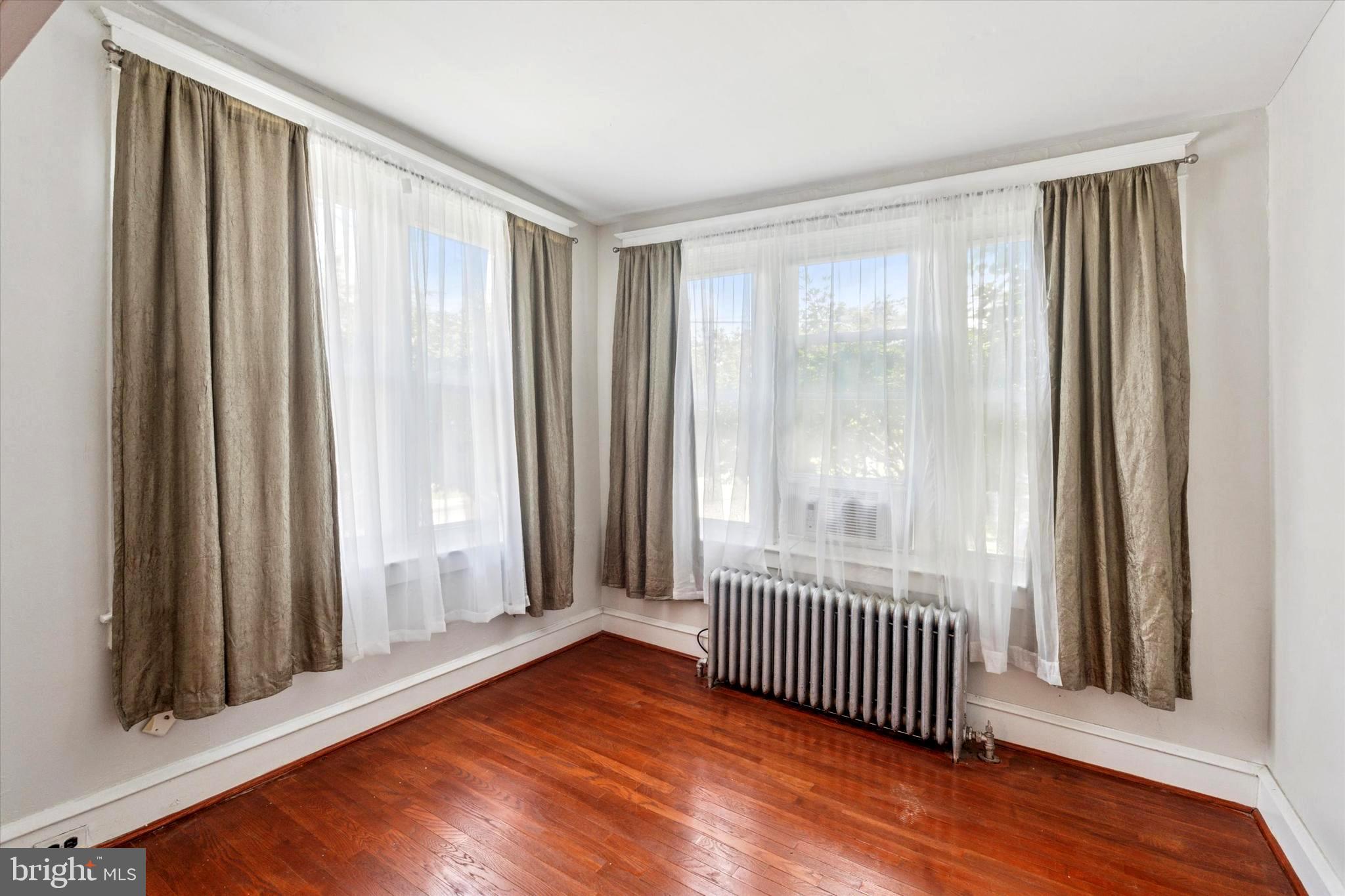 124 Arnold Road Ardmore, PA 19003 - Photo 8 of 24 a view of a room with wooden floor and windows