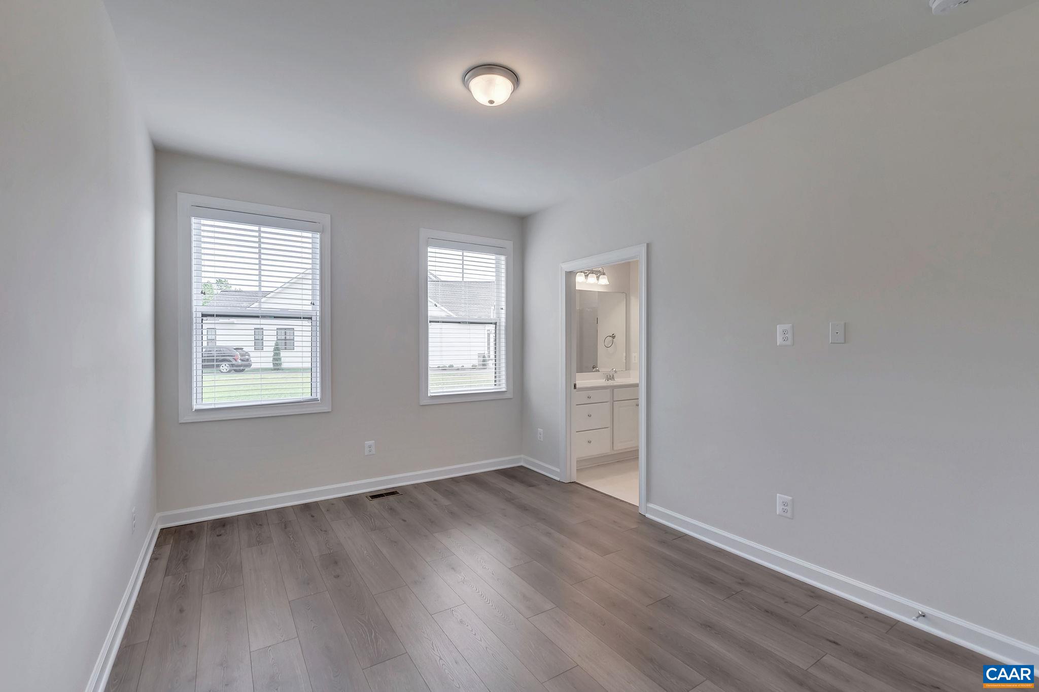 106 Cliffstone Boulevard Charlottesville, VA 22911 - Photo 10 of 29 an empty room with wooden floor and windows