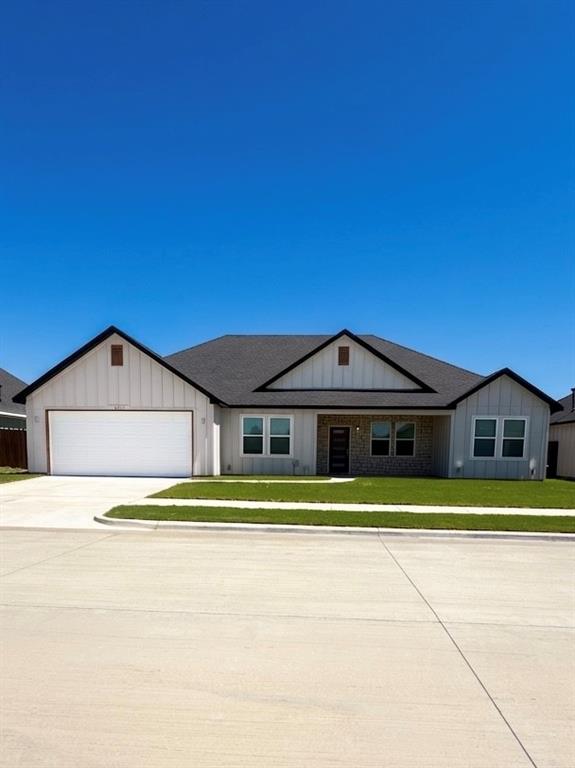 532 Highview Court Godley, TX 76044 - Photo 1 of 3 View of front of property featuring board and batten siding, concrete driveway, a front yard, a garage, and roof with shingles
