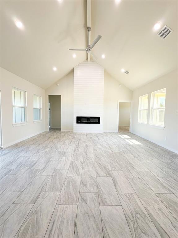 532 Highview Court Godley, TX 76044 - Photo 2 of 3 Unfurnished living room featuring ceiling fan, a fireplace, and recessed lighting