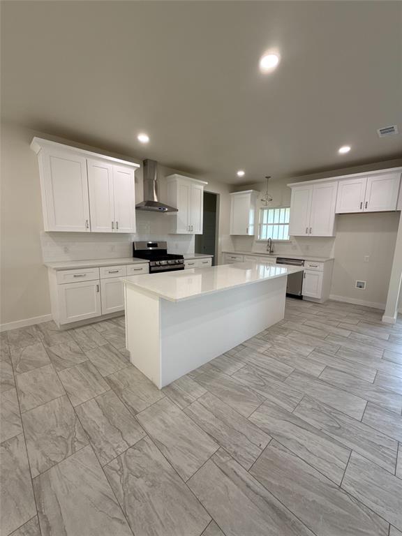 532 Highview Court Godley, TX 76044 - Photo 3 of 3 Kitchen with stainless steel appliances, a kitchen island, white cabinets, recessed lighting, and light stone countertops