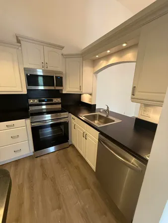 a kitchen with stainless steel appliances a stove a microwave and a refrigerator