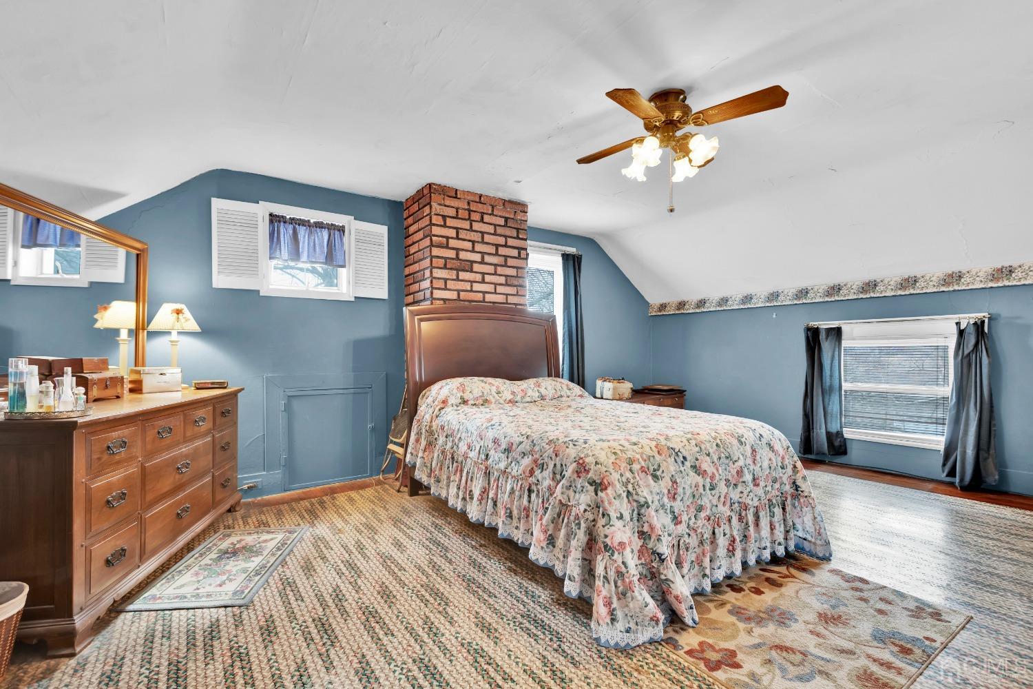 184 Creek Road Keansburg, NJ 07734 - Photo 15 of 29 a bedroom with a bed and a chandelier