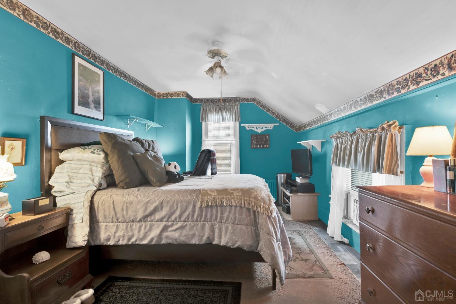 184 Creek Road Keansburg, NJ 07734 - Photo 16 of 29 a bedroom with a bed and a chandelier