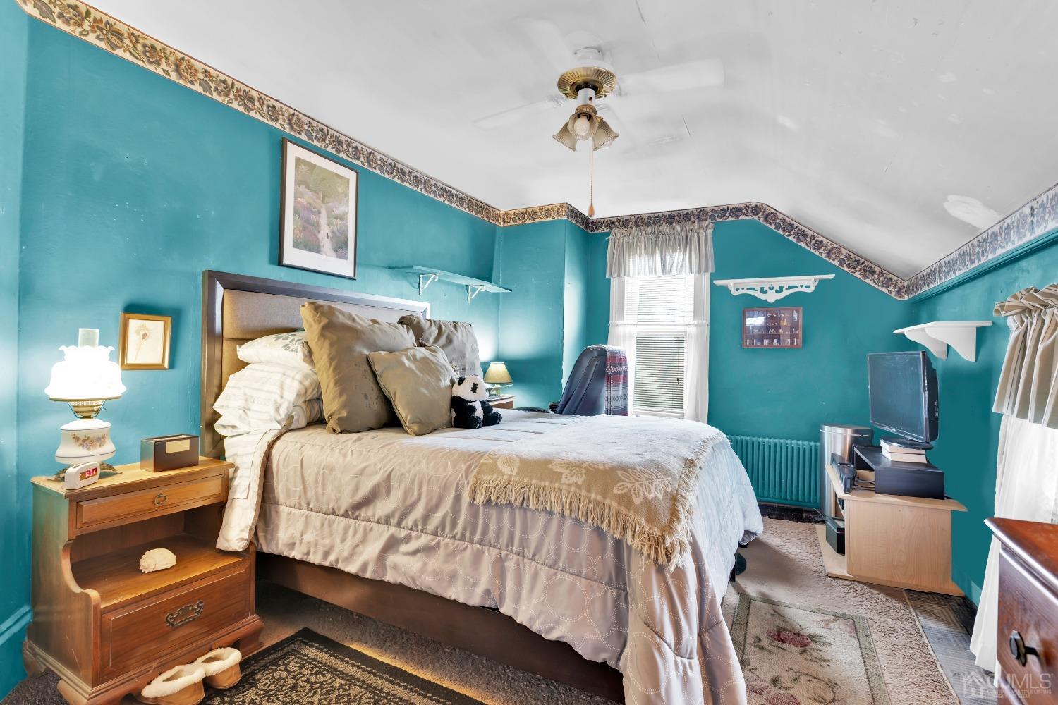184 Creek Road Keansburg, NJ 07734 - Photo 17 of 29 a bedroom with a bed and a chandelier