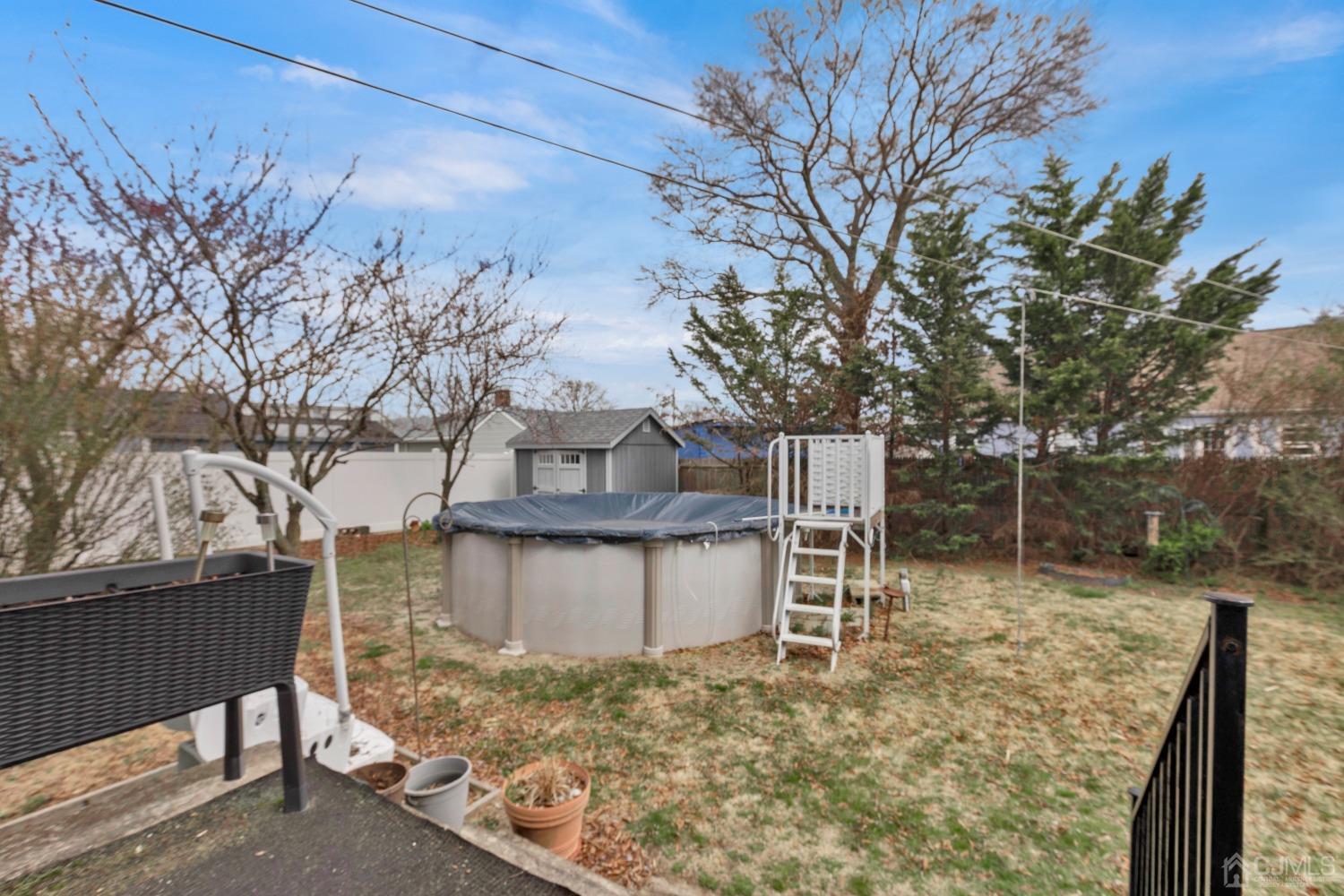 184 Creek Road Keansburg, NJ 07734 - Photo 20 of 29 a backyard of a house with table and chairs