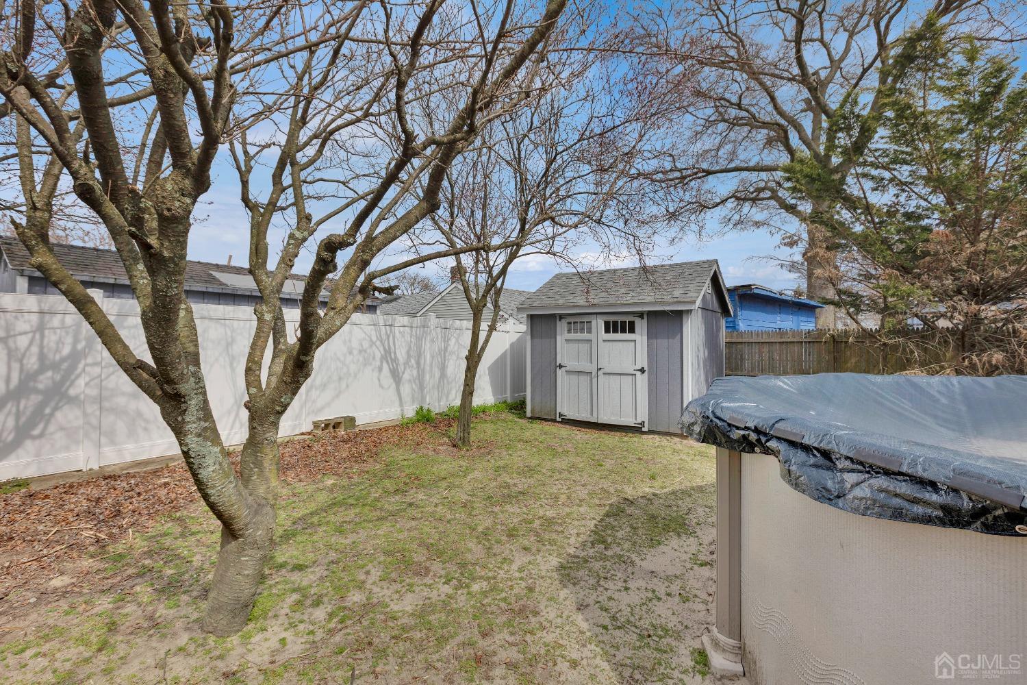 184 Creek Road Keansburg, NJ 07734 - Photo 23 of 29 a house with trees in front of it