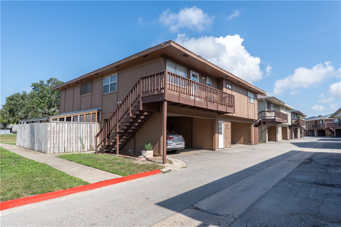 6107 Hidden Wood Corpus Christi, TX 78412 - Photo 1 of 9 a view of a house with wooden fence