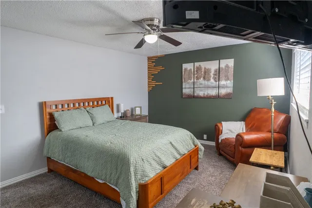 a bedroom with a bed and chair